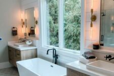 a modern cottage bathroom with shiplap on the walls, a geo tile floor, stained vanities, a square tub by the window