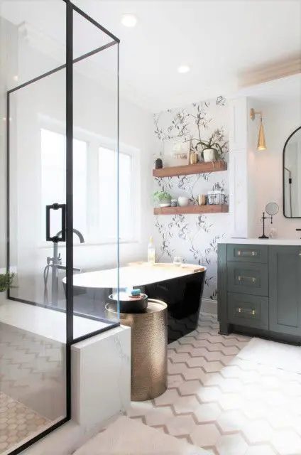 a modern farmhouse bathroom with a niche with mirrors, a grey vanity, a black tub, a shower space, open shelves and potted plants