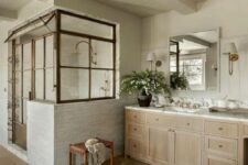 a modern farmhouse bathroom with shiplap and skinny tiles, a timber vanity, a shower space, a wooden stool and a mirror