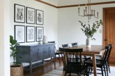 a modern farmhouse dining room with a vintage grey sideboard, a stained table and black chairs, a striped rug, a gallery wall