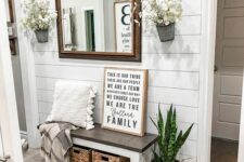 a lovely entryway with a shiplap wall