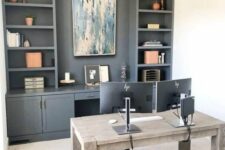 a modern farmhouse home office with a grey storage unit, with open shelves and cabinets, a stained wooden desk, a chair and a bubble chandelier