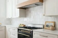 a modern farmhouse kitchen in soft creamy shades, with a white zellige tile backsplash and white stone countertops