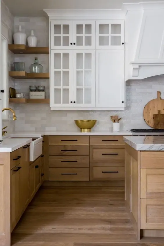 a modern farmhouse kitchen with stained and white cabinets, white stone countertops, a skinny tile backsplash and open shelves