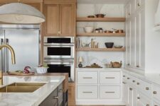a modern farmhouse kitchen with white cabinets, a black kitchen island, white stone countertops, open shelves and stained storage units