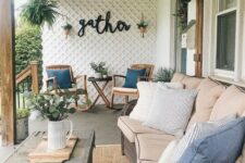 a modern farmhouse terrace with stained rockers, a wicker sofa, a shabby chic coffee table and potted plants