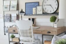 a neutral farmhouse home office with a wooden desk, open shelving, a vintage white chair and a ledge