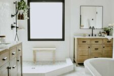 a neutral modern farmhouse bathroom with a shower space and a tub, a hex tile floor, timber vanitites, potted greenery and black hardware