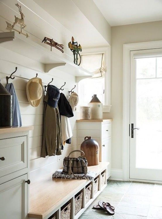 A neutral modern farmhouse entryway with shiplap walls, white dressers and a built in bench, a racj and some shelves