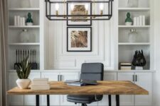a neutral modern farmhouse home office with a large storage unit, a lightweight desk, a black chair and a neutral pouf, a frame chandelier