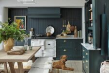 a teal modern farmhouse kitchen with a beadboard backsplash, white stone countertops, a small dining set of wood
