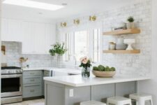 a two-tone modern farmhouse kitchen with white and grey cabinets, open shelves, white marble tiles and metal stools