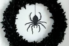 02 a black faux flower wreath and a black glitter spider is a stunning solution for decorating your front door and it looks elegant