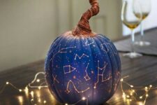 05 a bright blue Halloween pumpkin with gold constellations and a whimsical wrapped stem is a catchy and lovely idea