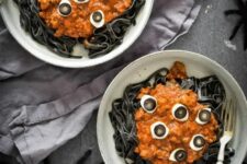05 black pasta with tomato and cheese on top and egg and olive eyeballs for Halloween parties