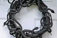 06 a black vine and faux snake wreath is a fantastic idea for Halloween, make one fast and easily using dollar store supplies