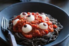 06 black pasta with tomato sauce and eyeballs is a spooky and bold Halloween food idea to make yourself