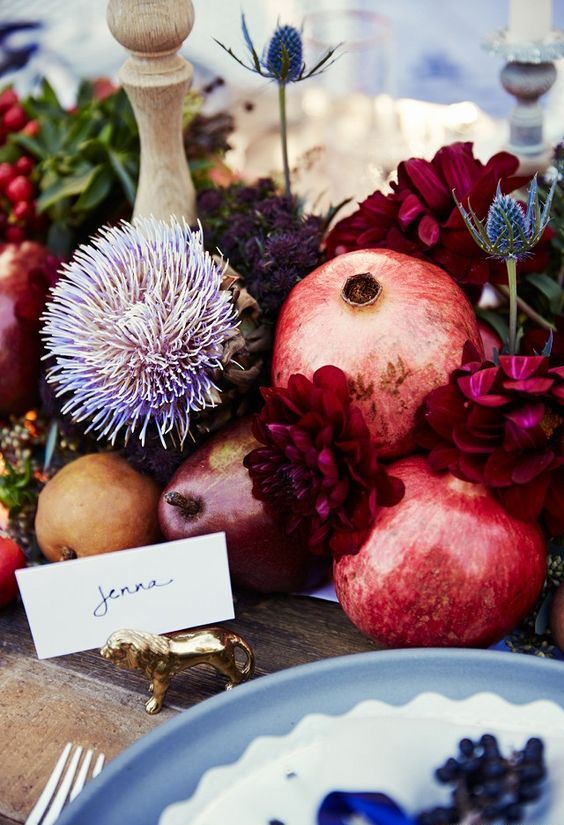 a bright and catchy centerpiece of bold dahlias, pears, pomegranates, thistles and apples is lovely for the fall
