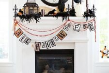 07 a whimsical Halloween mantel with feathers and blackbirds, white pumpkins, candles, a cage and beads and garlands