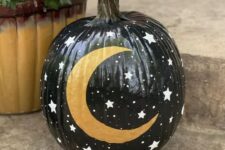 08 a black Halloween pumpkin with little stars and a gold moon is a great solution for celestial decor