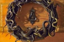 08 a black vine wreath with lots of snakes is a timeless front door decoration for Halloween