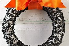 08 an elegant Halloween wreath covered with plastic ants, with a black orange ribbon bow is a scary and bold idea