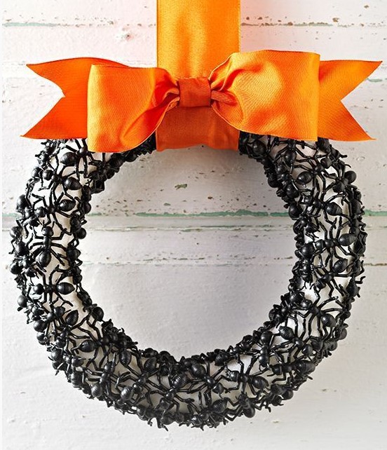 an elegant Halloween wreath covered with plastic ants, with a black orange ribbon bow is a scary and bold idea