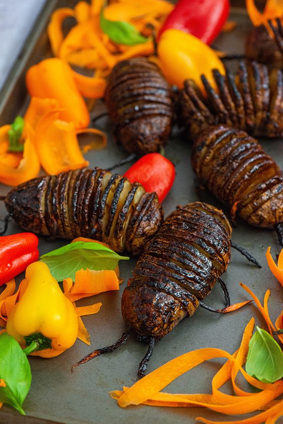 Creepy looking baked hasselback potatoes made to look like bugs are the perfect Halloween healthy snack