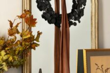 08 elegant Halloween mirror decor with a black foliage wreath and a rust ribbon bow is amazing