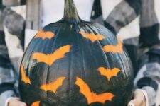 09 a black pumpkin stenciled with bats is a great idea for a modern rustic party or for your porch and it’s easy to make