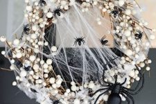 10 a stylish and scary Halloween wreath with lots of black spiders and a large one, realistic spiderweb and other stuff just wows