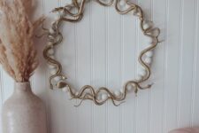 11 a glam gold snake wreath with large pearls is a nice and chic idea for a glam Halloween space