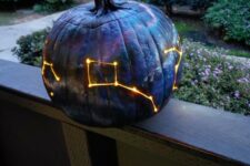 11 a gorgeous galaxy pumpkin luminary in black, navy and purple is a fantastic idea for Halloween, it looks bold