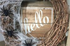11 a stylish vine Halloween wreath with realistic spiderweb and black spiders is a cool solution for Halloween and it brings a Halloween feel at once