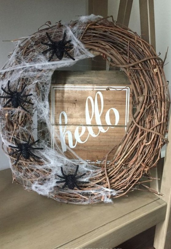 a stylish vine Halloween wreath with realistic spiderweb and black spiders is a cool solution for Halloween and it brings a Halloween feel at once