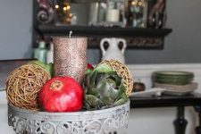 12 a catchy fall centerpiece with a candle, vine spheres, pomegranates and veggies is what you can fast and easily make