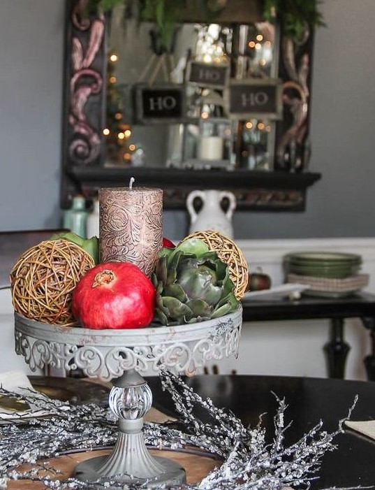 a catchy fall centerpiece with a candle, vine spheres, pomegranates and veggies is what you can fast and easily make