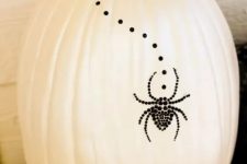 14 a white pumpkin with black studs and a black spider of them is a creative and cool non-carving pumpkin idea