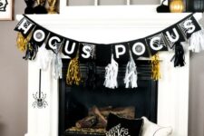 16 a glam Halloween mantel with gilded pumpkins, candleholders, black pumpkins, spiders and bright tassels