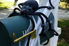 17 a black letter box on a pillar, with spiderweb and a large black spider is easy and fun Halloween decor that brings a Halloween feel