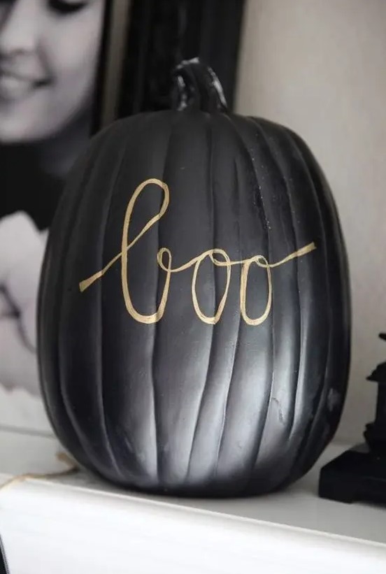 a matte black pumpkin with gold calligraphy letters made with a sharpie is a very easy and cool idea