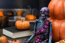 18 a black meditating skeleton covered with purple spiders is a cool and bold idea to decorate your space for Halloween