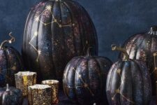 18 an arrangement of jaw-dropping black, purple and blue constellation pumpkins with gold constellations is fantastic