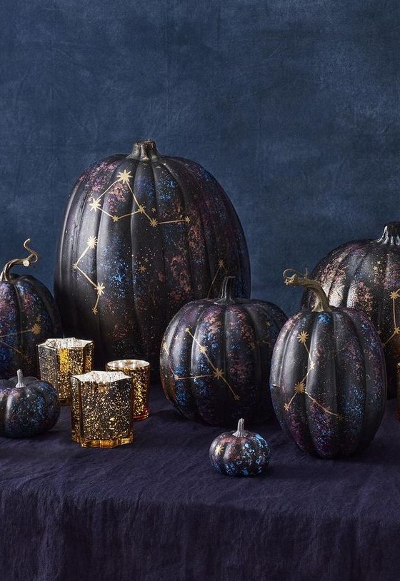 An arrangement of jaw dropping black, purple and blue constellation pumpkins with gold constellations is fantastic