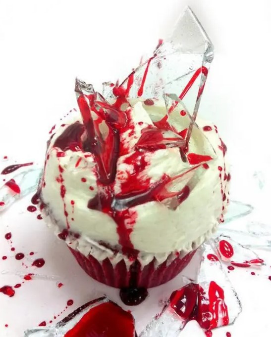 a bloody cupcake with lots of blood and shards is a cool and creative idea for a Halloween party