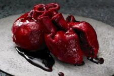 21 a bloody human heart cake is a bold and scary idea of a Halloween party dessert that you can order to impress everyone