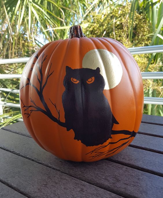 a painted Halloween pumpkin with a moon and an owl is a cool and bold decoration, and you need only some paint