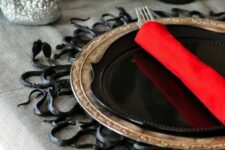 22 a black snake placemat will make your Halloween tablescape very spooky and special