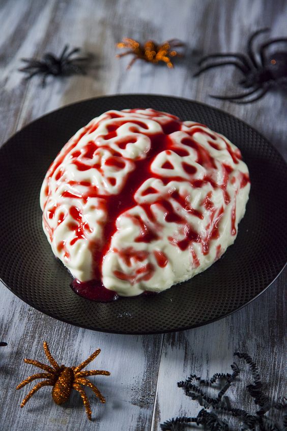 A brain shaped panna cotta with strawberry sauce is a scary Halloween dessert to try