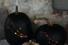 22 stylish black drilled pumpkins with lights inside instead of usual spooky carved ones are a very sophisticated Halloween decoration